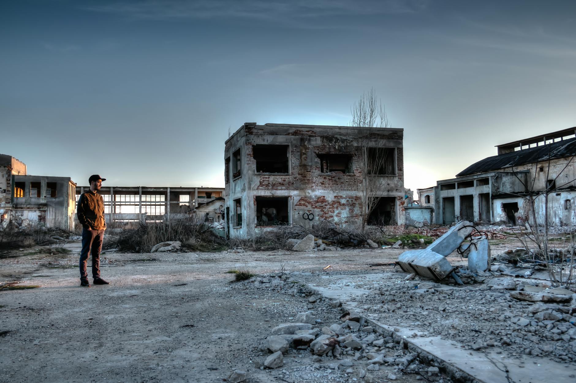 man standing near ruined buildings